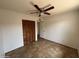 Bedroom with tile flooring, ceiling fan, and closet featuring bifold doors at 1714 W Villa Rita Dr, Phoenix, AZ 85023