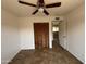 Bedroom with tile flooring, ceiling fan, and closet featuring bifold doors at 1714 W Villa Rita Dr, Phoenix, AZ 85023