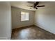 Bedroom featuring tile floors, a window with a view, and a ceiling fan at 1714 W Villa Rita Dr, Phoenix, AZ 85023
