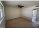 This is a spacious bedroom with neutral carpeting, a ceiling fan, and a double-door closet at 1714 W Villa Rita Dr, Phoenix, AZ 85023