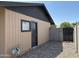 Exterior home featuring a side entrance, rock landscaping, and a fenced yard at 1714 W Villa Rita Dr, Phoenix, AZ 85023