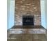 Close-up of the brick fireplace with a black metal screen and hearth at 1714 W Villa Rita Dr, Phoenix, AZ 85023