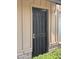 A close up of the front door with security screen, siding and brick detail at 1714 W Villa Rita Dr, Phoenix, AZ 85023