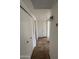 Hallway featuring tile floor, white walls, multiple closets, and two doorways at 1714 W Villa Rita Dr, Phoenix, AZ 85023