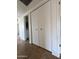 A clean hallway with bi-fold doors on the closet provides easy access to storage solutions at 1714 W Villa Rita Dr, Phoenix, AZ 85023