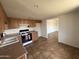 Bright kitchen featuring wooden cabinets, modern appliances, and tile flooring at 1714 W Villa Rita Dr, Phoenix, AZ 85023