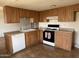 An efficient kitchen layout, including a stove, cabinets, and a double sink for easy meal prep at 1714 W Villa Rita Dr, Phoenix, AZ 85023