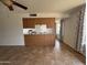 Open-concept kitchen featuring light wood cabinets and tile flooring, with a view to the dining area at 1714 W Villa Rita Dr, Phoenix, AZ 85023