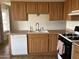 Well-lit kitchen showcasing wooden cabinetry, white appliances, and a tile floor at 1714 W Villa Rita Dr, Phoenix, AZ 85023