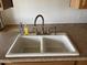 A clean kitchen sink featuring a modern faucet with soap and tile floors at 1714 W Villa Rita Dr, Phoenix, AZ 85023