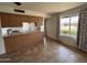 Open concept kitchen with eat-in breakfast bar and tile floors at 1714 W Villa Rita Dr, Phoenix, AZ 85023