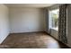 A cozy living room features tile flooring and a window with elegant patterned curtains at 1714 W Villa Rita Dr, Phoenix, AZ 85023