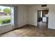 Sunlit living area with tile flooring, offering views into the kitchen and backyard at 1714 W Villa Rita Dr, Phoenix, AZ 85023