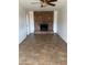 Spacious living room with a brick fireplace, tile flooring, and a ceiling fan at 1714 W Villa Rita Dr, Phoenix, AZ 85023