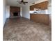 Living room showcasing a brick fireplace and view into the kitchen at 1714 W Villa Rita Dr, Phoenix, AZ 85023