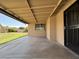 Backyard patio with partial view of the grassy lawn and privacy fence at 1714 W Villa Rita Dr, Phoenix, AZ 85023