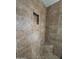 Tiled shower stall featuring built-in niche and seat, offering both style and functionality at 1714 W Villa Rita Dr, Phoenix, AZ 85023