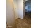 Small storage room showing various cabinets, a door, and a glimpse of the tile flooring at 1714 W Villa Rita Dr, Phoenix, AZ 85023