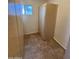 Compact storage room with cabinets and a window, all designed for efficient storage at 1714 W Villa Rita Dr, Phoenix, AZ 85023