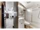Bathroom featuring a shower, vanity and a view of a living space in an open concept home at 17200 W Bell Rd # 47, Surprise, AZ 85374