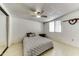 Cozy bedroom featuring wood-look flooring, a ceiling fan, and mirrored closet doors at 17200 W Bell Rd # 47, Surprise, AZ 85374