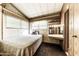 Bedroom featuring a full-sized bed, makeup vanity, and a large window for natural light at 17200 W Bell Rd # 47, Surprise, AZ 85374