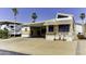 Mobile home exterior featuring a carport, small front yard decorations and awnings at 17200 W Bell Rd # 47, Surprise, AZ 85374