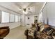 Spacious living room featuring comfortable seating, neutral carpet, and ample natural light from multiple windows at 17200 W Bell Rd # 47, Surprise, AZ 85374
