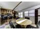 Living room features laminate flooring, dining table, and seating at the kitchen bar at 17200 W Bell Rd # 47, Surprise, AZ 85374
