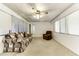 Living room featuring neutral carpet, plenty of windows, ceiling fan, and comfortable seating at 17200 W Bell Rd # 47, Surprise, AZ 85374