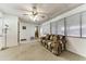 Living room with floral sofa, fan and lots of light from the many windows at 17200 W Bell Rd # 47, Surprise, AZ 85374