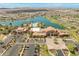 Aerial view of the community clubhouse, pool, lake, and surrounding residential area at 17886 W Brookwood Dr, Goodyear, AZ 85338