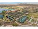 Aerial view featuring the community's tennis courts, clubhouse, and surrounding residential neighborhood at 17886 W Brookwood Dr, Goodyear, AZ 85338