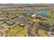 Beautiful aerial shot showcasing the community's common areas including the lake, pool, and tennis courts at 17886 W Brookwood Dr, Goodyear, AZ 85338
