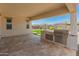 Covered patio featuring stone floors, a built-in grill, and views of the desert landscaping in the backyard at 17886 W Brookwood Dr, Goodyear, AZ 85338