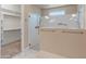Contemporary bathroom with glass-enclosed shower and open walk-in closet at 17886 W Brookwood Dr, Goodyear, AZ 85338