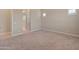 Cozy bedroom featuring neutral carpet, ensuite bathroom, and ample natural light at 17886 W Brookwood Dr, Goodyear, AZ 85338