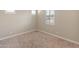 Bedroom featuring neutral paint, plantation shutters, and carpeted flooring at 17886 W Brookwood Dr, Goodyear, AZ 85338
