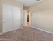 Bedroom featuring neutral paint, closet, and carpeted flooring at 17886 W Brookwood Dr, Goodyear, AZ 85338