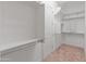 Spacious walk-in closet with shelving and closet rods, carpeted floor at 17886 W Brookwood Dr, Goodyear, AZ 85338