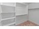 Walk-in closet featuring built-in shelving and closet rods, carpeted floor at 17886 W Brookwood Dr, Goodyear, AZ 85338
