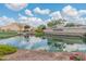 Community entrance with a pond, landscaping, and signage at 17886 W Brookwood Dr, Goodyear, AZ 85338