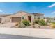 Charming single-story home with a well-manicured front yard and attached two-car garage at 17886 W Brookwood Dr, Goodyear, AZ 85338