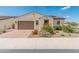 Charming single-story home with low maintenance desert landscaping and brick driveway, presenting inviting curb appeal at 17886 W Brookwood Dr, Goodyear, AZ 85338