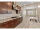 Stylish kitchen with granite countertops, stainless steel hood, and view to dining area at 17886 W Brookwood Dr, Goodyear, AZ 85338