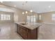 Beautiful kitchen island with granite countertops and stainless steel sink with views of the backyard at 17886 W Brookwood Dr, Goodyear, AZ 85338