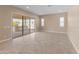 Spacious living room featuring a sliding glass door leading to an outdoor living area at 17886 W Brookwood Dr, Goodyear, AZ 85338