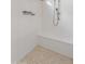 Modern shower featuring a built-in bench, handheld shower head, and tiled floor at 17886 W Brookwood Dr, Goodyear, AZ 85338
