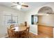 A cozy dining area with wood flooring and table is open to the adjacent living area with ceiling fan at 205 S Higley Rd # 293, Mesa, AZ 85206