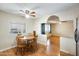 A cozy dining area transitions into an open living space with wood flooring, ceiling fan, and natural light at 205 S Higley Rd # 293, Mesa, AZ 85206